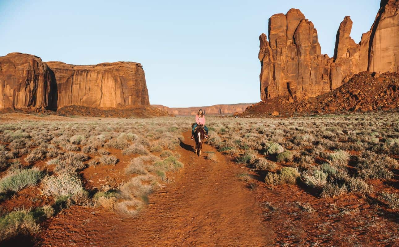 Horseback riding in Monument Valley at sunrise for a memorable Utah date idea